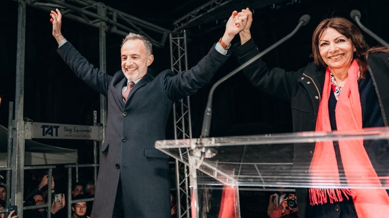 Flash photo of Anne Hidalgo Mayor of Paris since 2014 and the outgoing mayor with Emmanuel Gregoire the new mayor of Paris and a French Socialist Party deputy representing Paris s 7th constituency arriving on stage hand in hand. After the victory of Emman