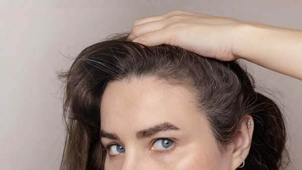 young Caucasian brunette woman has grey hair