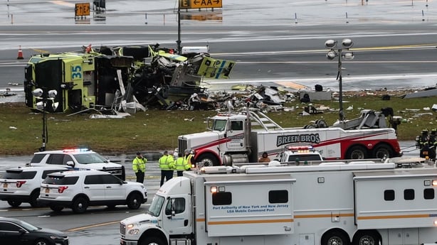 A Port Authority fire truck sits on the runway after colliding with an Air Canada Express CRJ-900 at LaGuardia Airport on March 23, 2026 in New York City