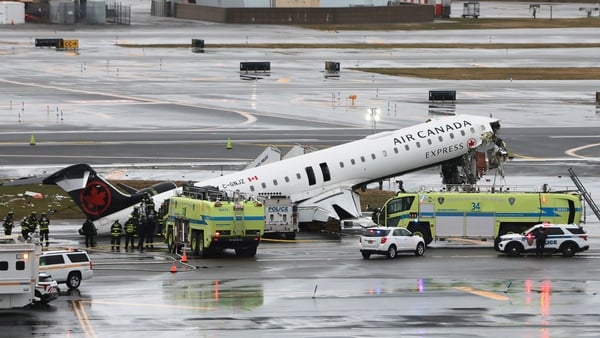 an Air Canada Express CRJ-900 sits on the runway after colliding with a Port Authority fire truck at LaGuardia Airport on March 23, 2026 in New York City