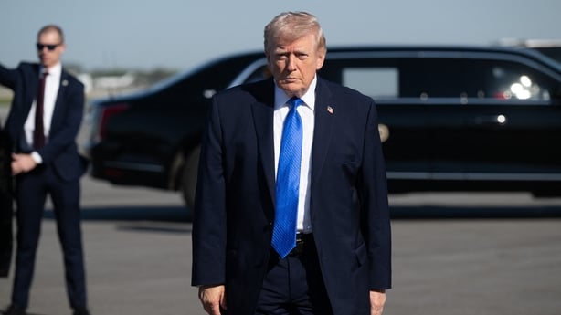 US President Donald Trump walks to speak to reporters before boarding Air Force One at Palm Beach International Airport in West Palm Beach, Florida, on March 23, 2026. President Donald Trump said Monday that there are "major points of agreement" in US-Iran talks which he said must result in Tehran g