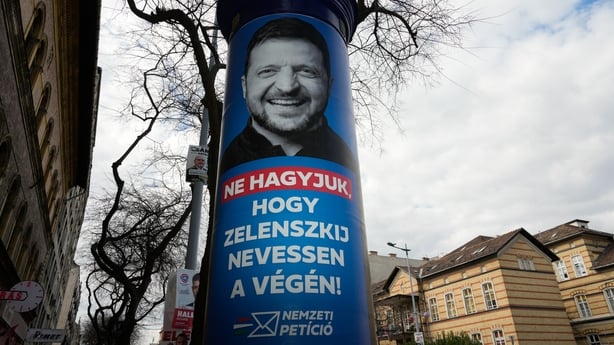 an election poster depicting an image of Volodymyr Zelenksy on a lamppost in budapest