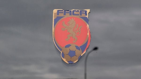 A sticker with the logo of Czech Football Association (FACR) is seen on the entrance door of the FACR headquarters, as the clouds reflect on the surface, in Prague, Czech Republic, on October 16, 2020. - Czech police detained 19 people including deputy Cz