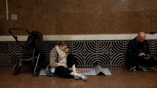 People take shelter at a metro station during an air strike alarm in Kyiv 