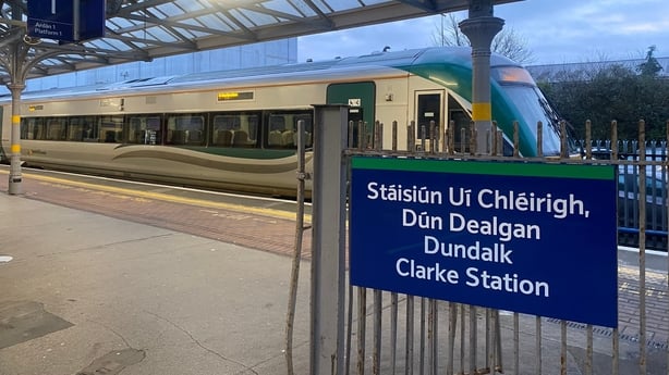 A sign which says 'Dundalk Clarke Station' is pictured next to a stabled train