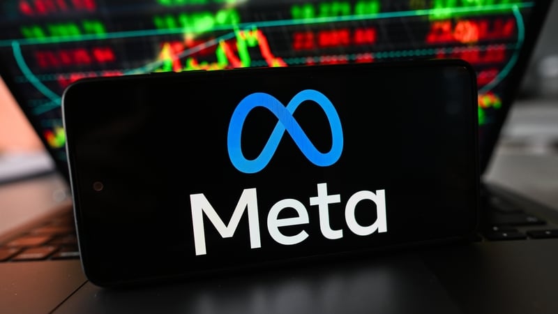 In this photo illustration, the Meta logo is displayed on a smartphone with stock market percentages in the background