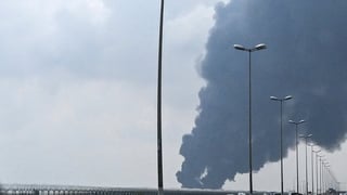 Smoke rises from the area of the Kuwait International Airport after a reported drone strike hit a fuel depot on March 25, 2026. Gulf countries called for Iran to immediately halt its strikes on their territory and provide full reparations, in a rare urgen
