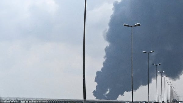 Smoke rises from the area of the Kuwait International Airport after a reported drone strike hit a fuel depot on March 25, 2026. Gulf countries called for Iran to immediately halt its strikes on their territory and provide full reparations, in a rare urgen