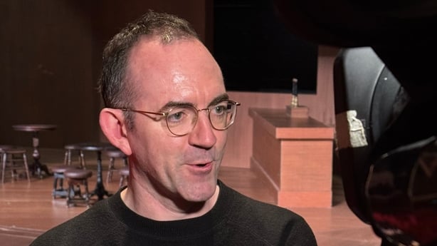 Headshot of Tom Creed talking to a reporter