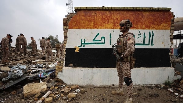 Iraqi soldiers inspect the site of a destroyed healthcare centre