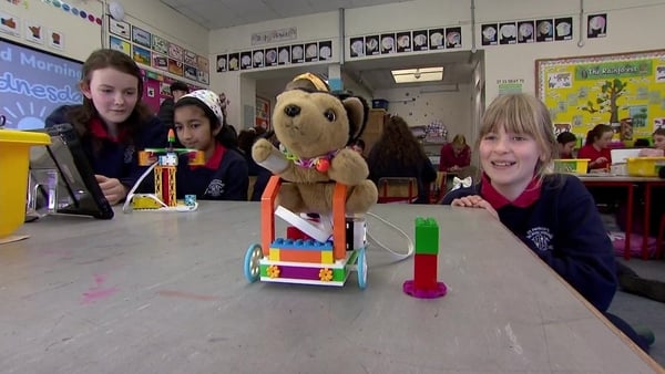 Children laughing as they control a teddy on a robot for World Maths Day