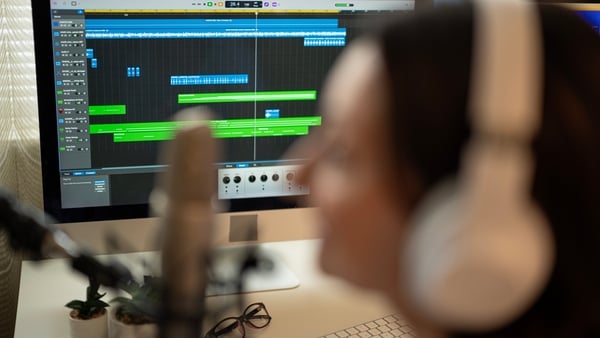 Modern online streaming services intertwined with traditional radio broadcast media. Woman speaking in podcast show in radio station. Air time in social media platforms & OTT media strategy, daily news & mass communications