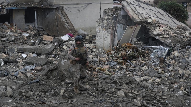 An Iraqi soldier stands guard at the site of a destroyed healthcare center in the Habbaniyah military base, which was targeted by in an airstrike killing seven security personnel and wounding 13 others, in Habbaniyah, west of Baghdad