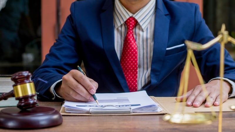 Close up lawyer businessman working or reading lawbook in office workplace for consultant lawyer concept.