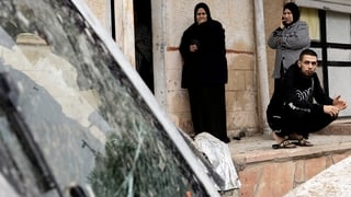 Residents inspect the impact site after part of a ballistic missile fired from Iran hit the Israeli - Arab city, leaving 2 injured on March 26, 2026 in Kfar Kasem, Israel