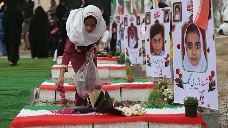 People gather at a cemetery to commemorate victims, most of them children, who were killed on a missile attack on a girls primary school in Minab, Hormozgan province, Iran