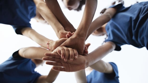 Directly below shot of students huddling under sky