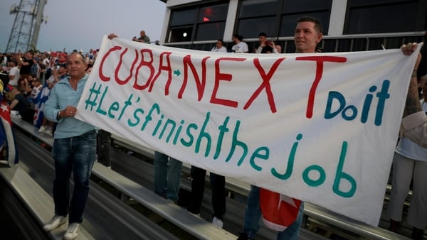 HIALEAH, FLORIDA - MARCH 24: People hold a banner that reads "Cuba Next Do it, Let's Finish the Job" at a Free Cuba rally that brought together political leaders, activists, artists and community members on March 24, 2026 in Hialeah, Florida. Rally-goers