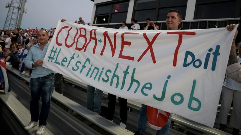 HIALEAH, FLORIDA - MARCH 24: People hold a banner that reads "Cuba Next Do it, Let's Finish the Job" at a Free Cuba rally that brought together political leaders, activists, artists and community members on March 24, 2026 in Hialeah, Florida. Rally-goers