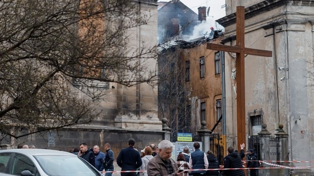 People stand near damaged Bernardine church and monastery after Russian drone attack on Lviv, Ukraine