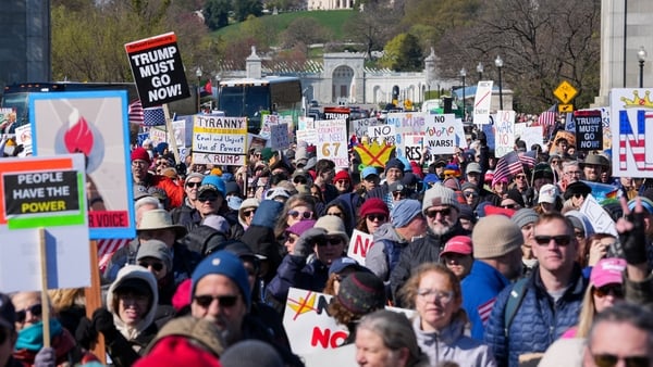 Demonstrators walk across the Memorial Bridge from Arlington, Virginia into Washington, DC, during the "No Kings" national day of protest on March 28, 2026. Nationwide protests against US President Donald Trump are expected Saturday as millions of people
