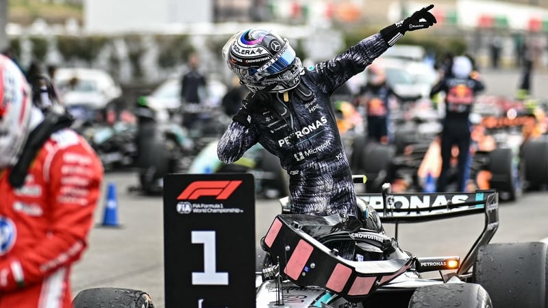 Mercedes' Italian driver Kimi Antonelli (R) celebrates his victory at the parc ferme past third placed Ferrari's Monegasque driver Charles Leclerc (L) after the Formula One Japanese Grand Prix at the Suzuka circuit in Suzuka, Mie prefecture on March 29, 2