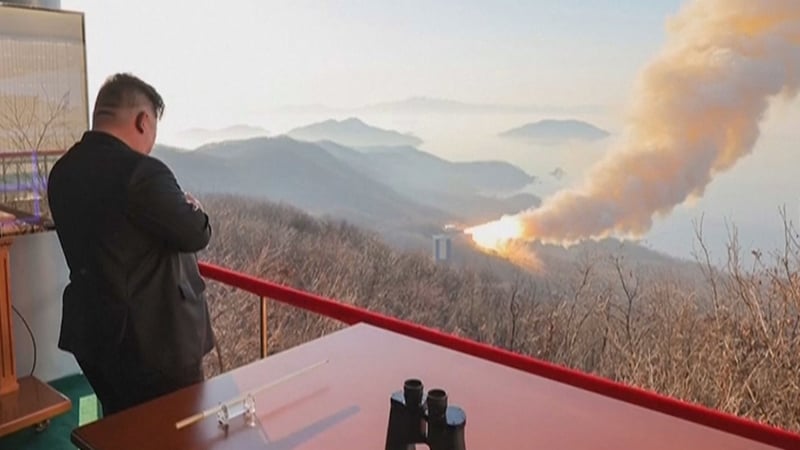 North Korea's Kim Jong Un observes a ground ejection test of a high-output solid-fuel engine