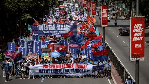 Transport workers and activists march as they stage a strike over surging fuel costs in Manila, Philippines