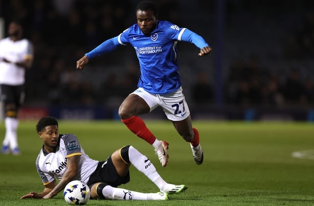 Millenic Alli of Portsmouth is tackled by Rhian Brewster of Derby County during the Sky Bet Championship match between Portsmouth and Derby County at Fratton Park on March 16, 2026 in Portsmouth, England.