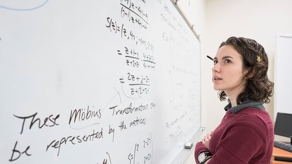 Caucasian college student reading whiteboard