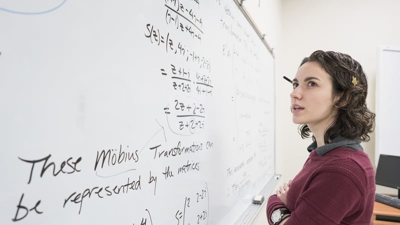 Caucasian college student reading whiteboard