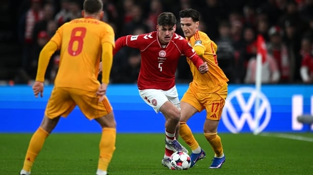 Joakim Maehle of Denmark runs with the ball while under pressure from Lirim Qamili of North Macedonia during the FIFA World Cup 2026 European Qualifiers KO play-offs match between Denmark and North Macedonia at Parken Stadium on March 26, 2026 in Copenhagen, Denmark. (Photo by Patrik Lundin - UEFA/U