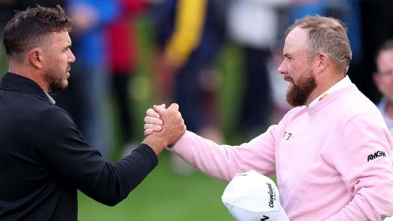 STRAFFAN, IRELAND - SEPTEMBER 04: Brooks Koepka of the United States and Shane Lowry of Ireland shake hands after finishing their round on the 9th green on day one of the Amgen Irish Open 2025 at The K Club on September 04, 2025 in Straffan, Ireland. (Pho
