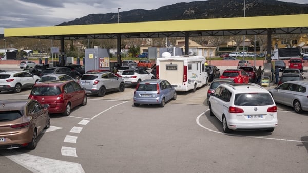 various vehicles line up at a petrol station in spain