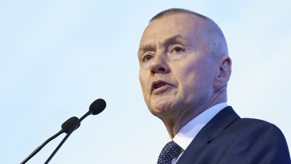 Headshot of Willie Walsh in a suit, shirt and tie speaking at a podium