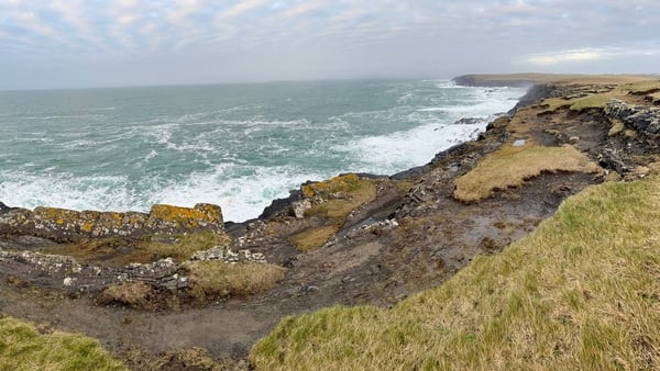 Rocks and a grassy area overlooking the sea