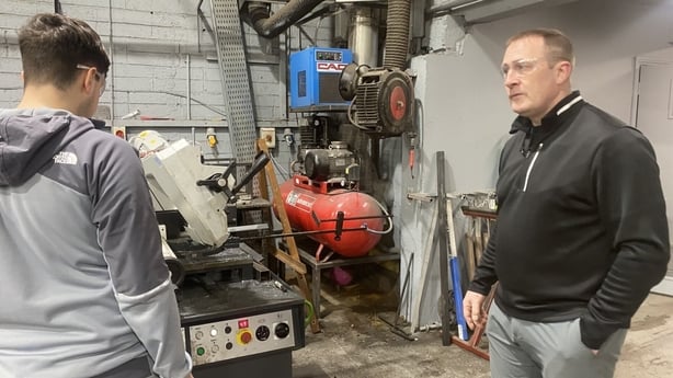 Damien Doran, a workshop supervisor, trains in a new recruit 