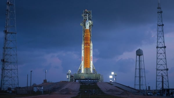 NASA's 322-foot-tall Artemis II Space Launch System rocket and Orion spacecraft stand on Launch Complex 39B at Kennedy Space Center
