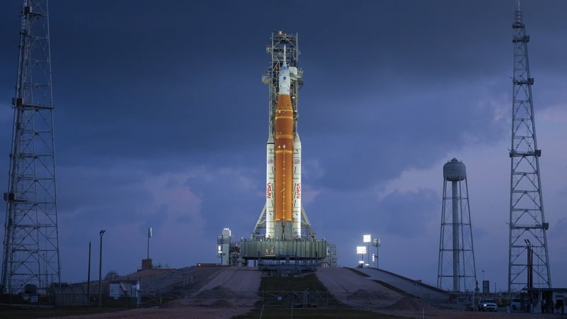 NASA's 322-foot-tall Artemis II Space Launch System rocket and Orion spacecraft stand on Launch Complex 39B at Kennedy Space Center