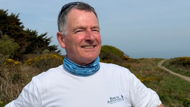 a photograph of shane o'doherty with the howth summit walk in the background