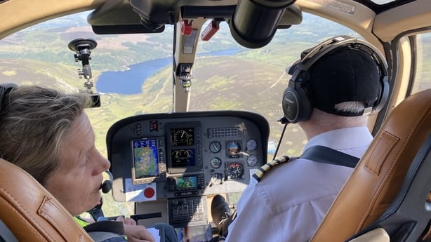 Two people in a helicopter over Co Wicklow