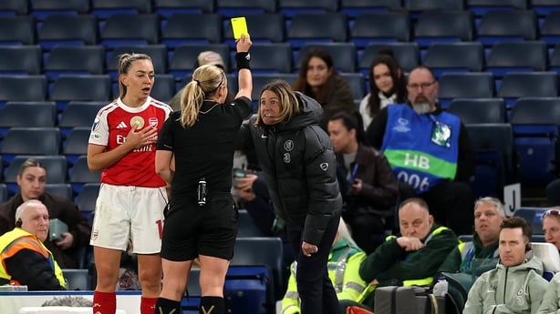 Referee Frida Mia Klarlund shows a yellow card to Sonia Bompastor, Manager of Chelsea, as Katie McCabe of Arsenal looks on during the UEFA Women's Champions League 2025/26 Quarter-finals Second Leg match between Chelsea and Arsenal at Stamford Bridge on April 01, 2026 in London, England.