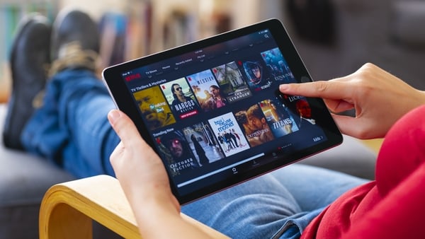 Viewer using tablet computer and looking at Netflix.