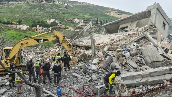 First responders search for survivors at the site of an overnight Israeli airstrike that targeted a house in the southern Lebanese village of Zibdine