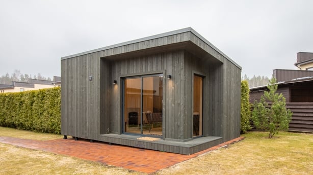 a wooden garden room with windows