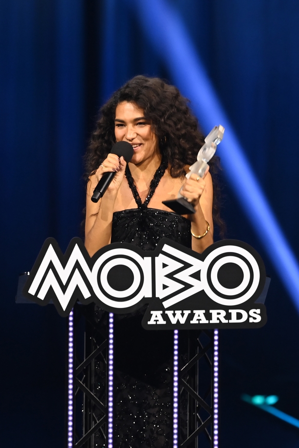 MANCHESTER, ENGLAND - MARCH 26: Olivia Dean wins the award for Song of the Year for 'Man I Need' onstage during the 2026 MOBO Awards at Co-op Live on March 26, 2026 in Manchester, England. (Photo by Joseph Okpako/Getty Images for MOBO)