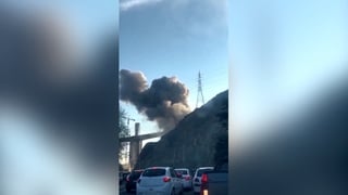 Smoke rises from Iran bridge hit by air strike