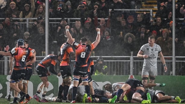 Teammates celebrate as Edinburgh Rugby's South African prop Boan Venter scores a try 