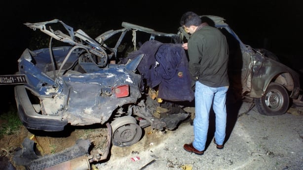 A man looks at the debris of Sheikh Abbas Musawi's car 