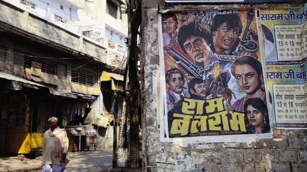 A poster advertises a Bollywood film at a bazaar near the Jami Masjid in Agra
